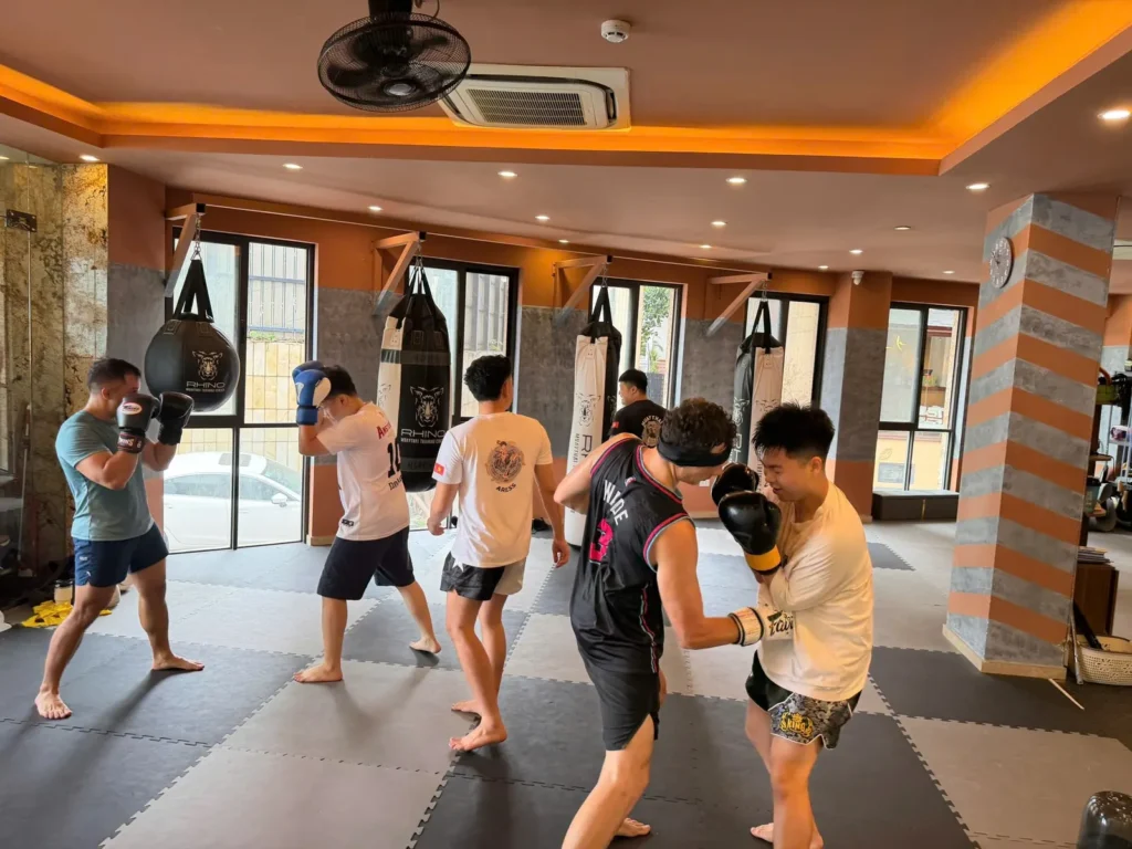 Small group Combat Fit class training on pads, drop-in Muay Thai in Hanoi