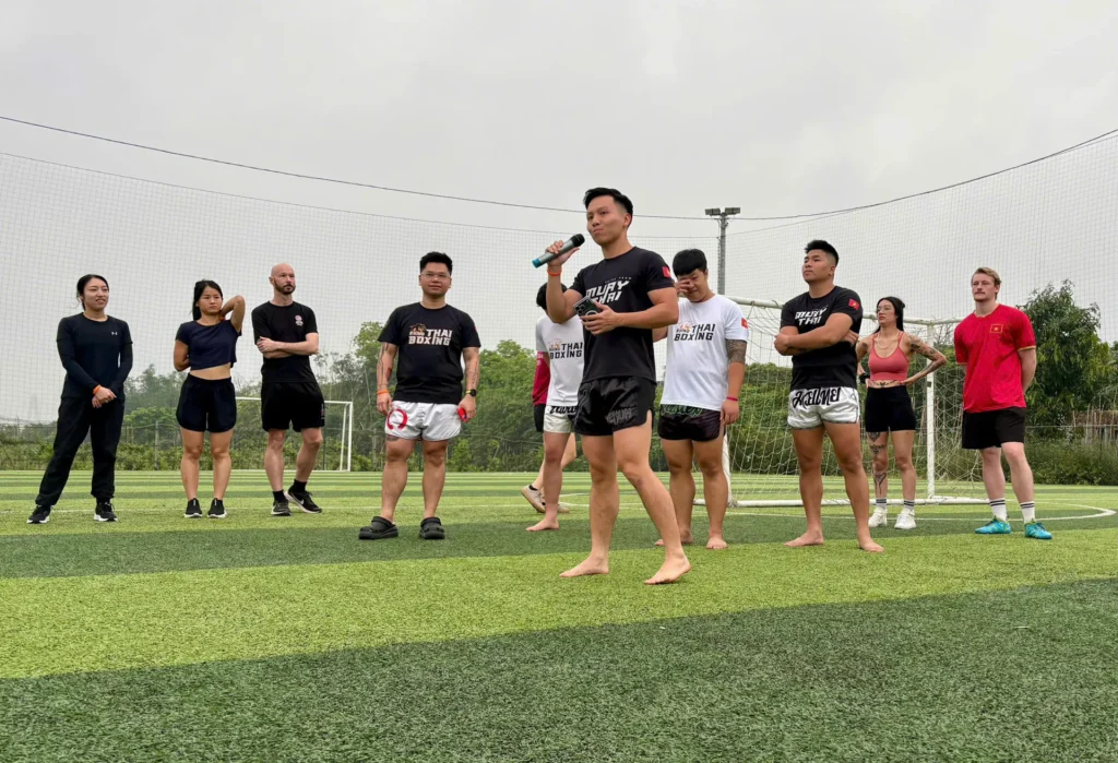 Members playing football on the pitch in mixed teams