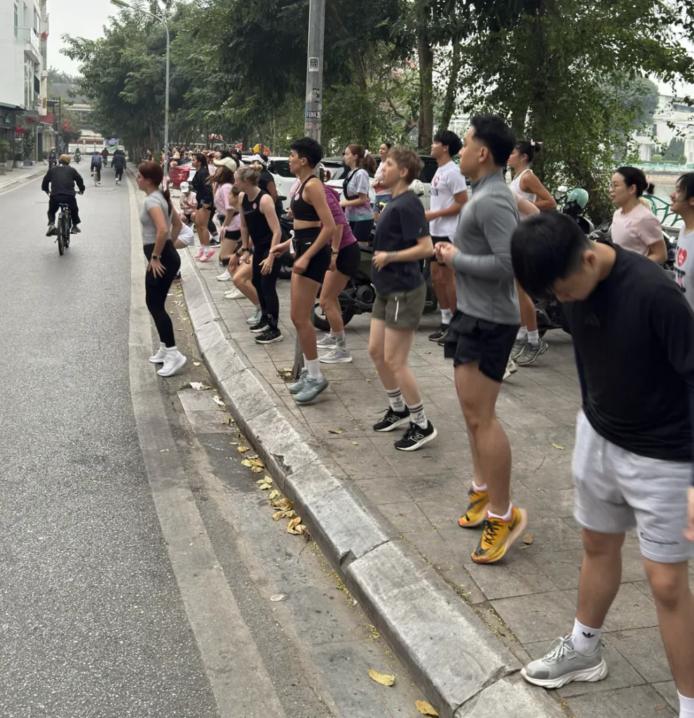 Muay Thai for women in Hanoi, runners warming up before the 5k in Tay Ho
